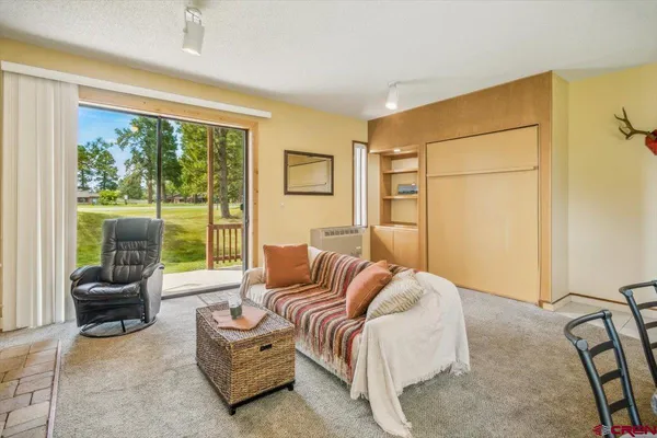 a bedroom with a bed and glass window
