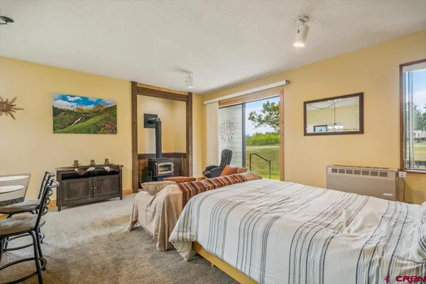 a bedroom with double bed and a window