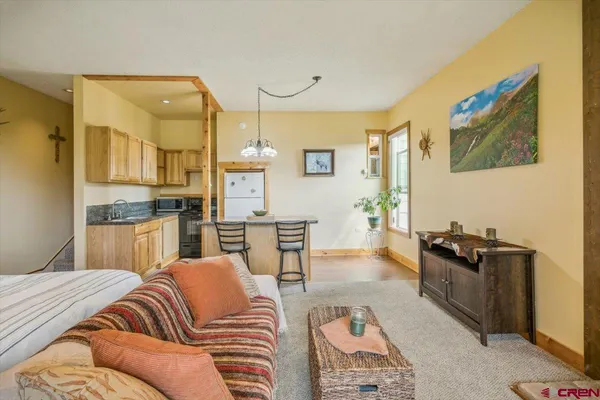a kitchen with a sink refrigerator and cabinets