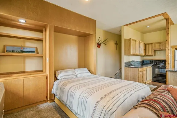 a bedroom with a bed and a cabinets