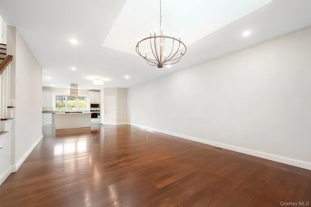 a living room with furniture a rug and white walls