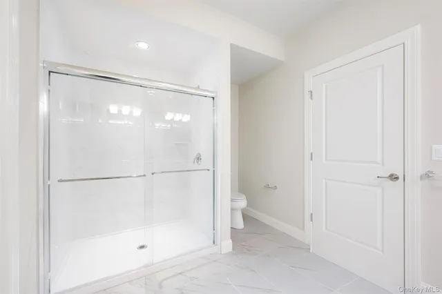 a bathroom with a glass shower door