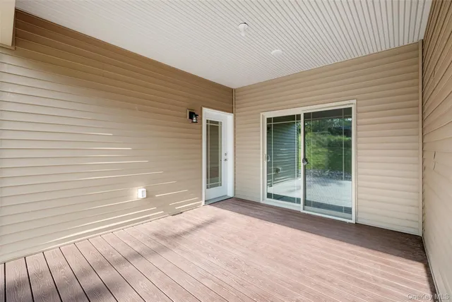 a view of a big house with a big yard and large trees