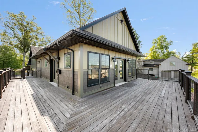 a view of backyard with swimming pool and green space
