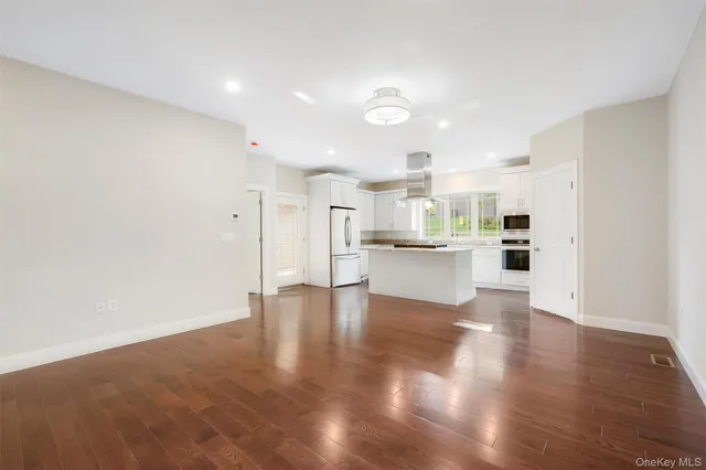 a view of kitchen and hall with wooden floor