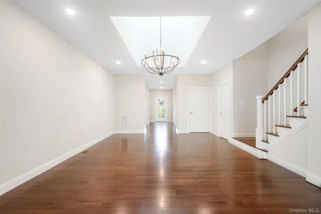 a view of a room with wooden floor water heater and windows
