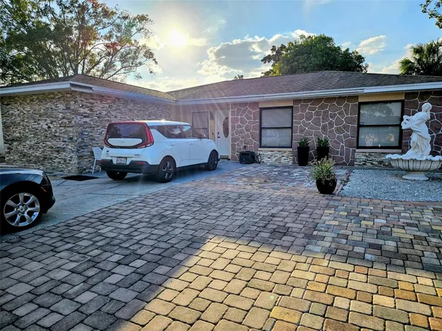 a view of a car that is parked in front of a house