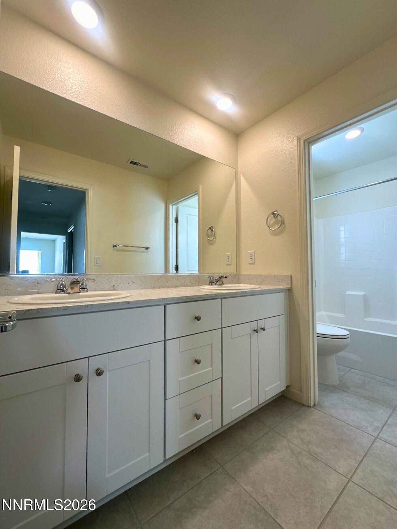 9007 Quail Grove Drive Reno, NV 89506 - Photo 14 of 18 a spacious bathroom with a granite countertop sink mirror and a