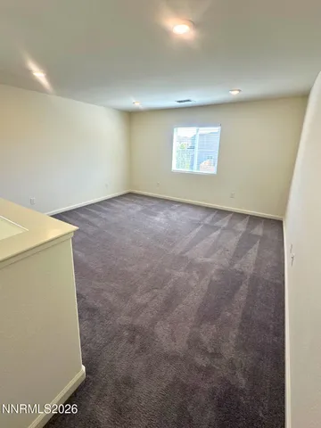 a view of an empty room and a window