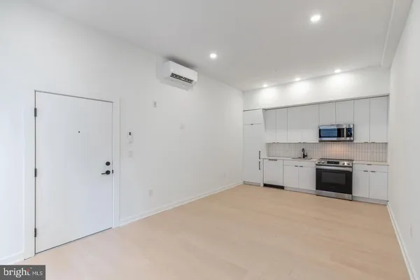 a kitchen with stainless steel appliances a refrigerator sink and stove