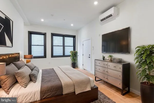 a bedroom with a large bed and a flat screen tv