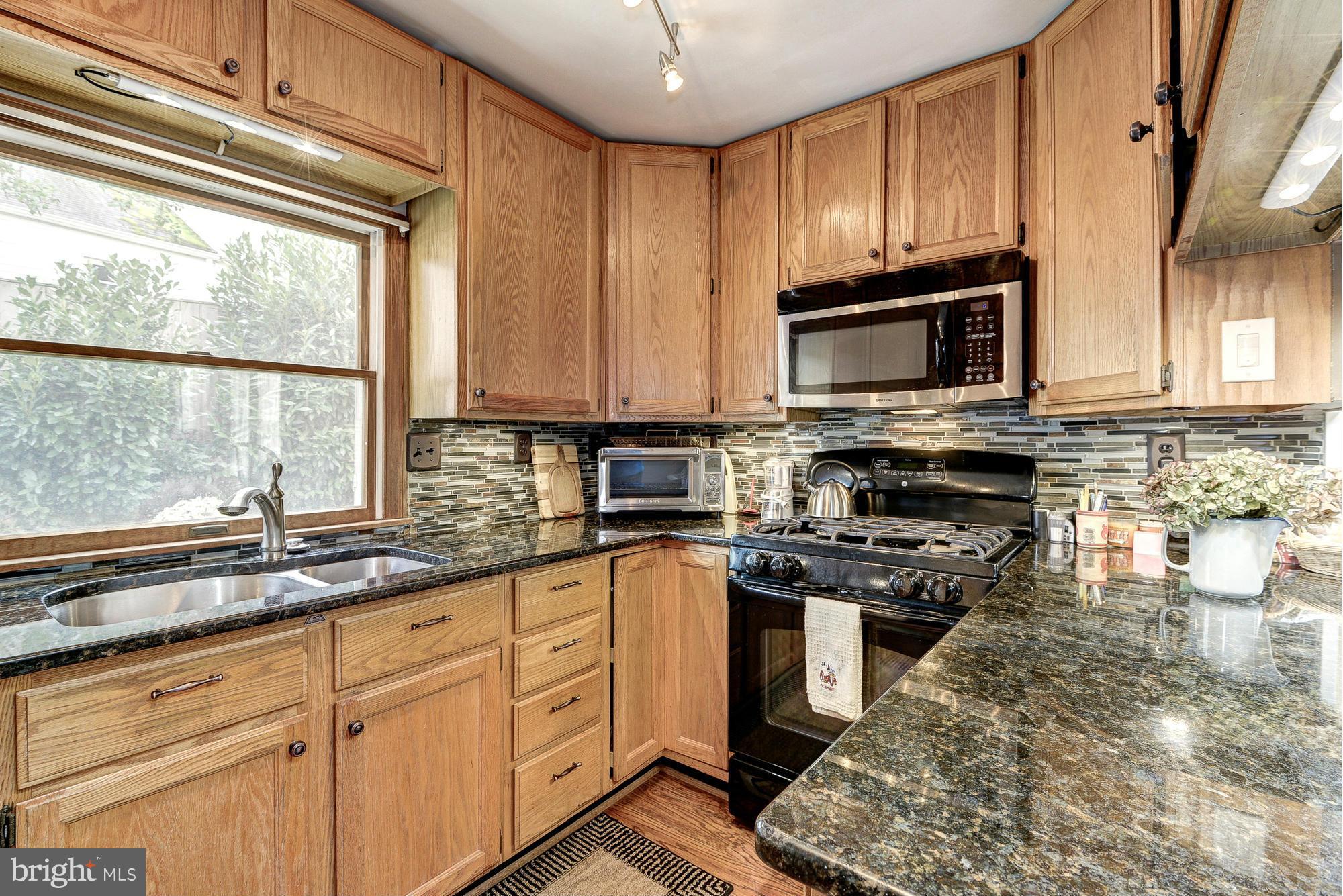 2034 Griffith Road Falls Church, VA 22043 - Photo 11 of 25 a kitchen with granite countertop a stove a sink and a microwave
