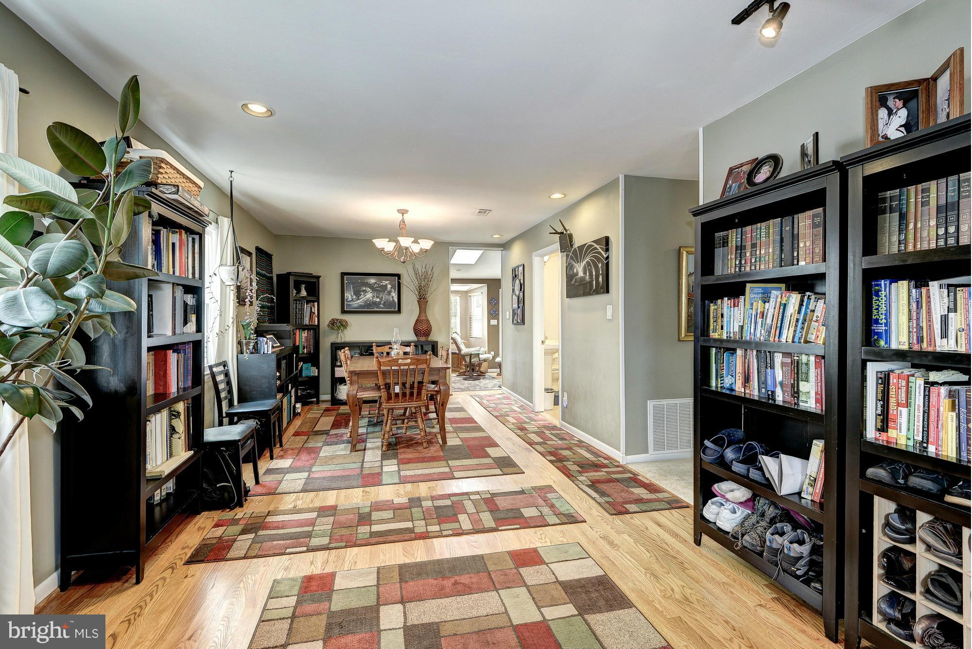 2034 Griffith Road Falls Church, VA 22043 - Photo 5 of 25 a living room with lots of furniture and a book shelf