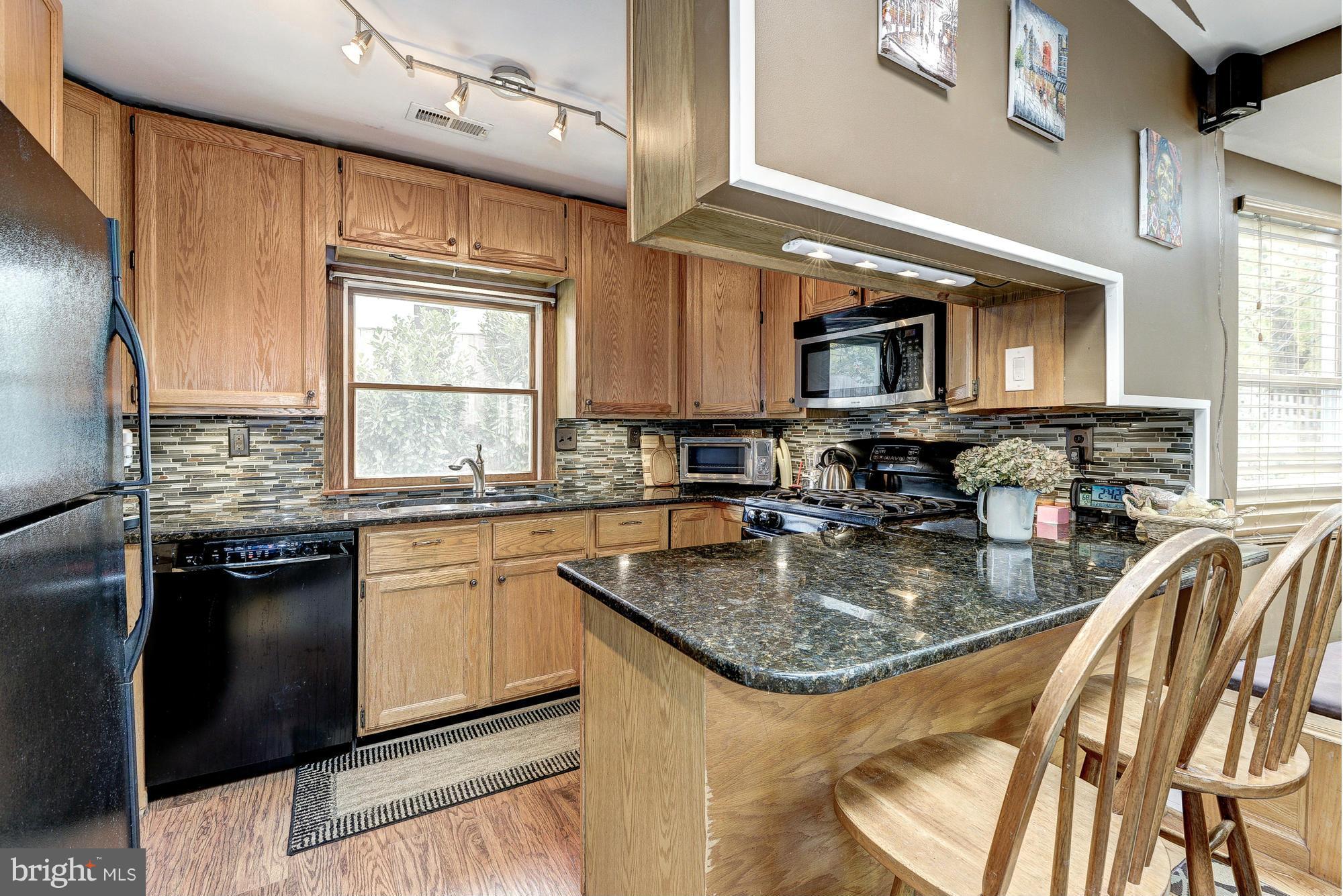 2034 Griffith Road Falls Church, VA 22043 - Photo 8 of 25 a kitchen with stainless steel appliances granite countertop a sink stove and refrigerator