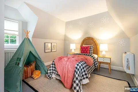 a bedroom with a bed and a mirror