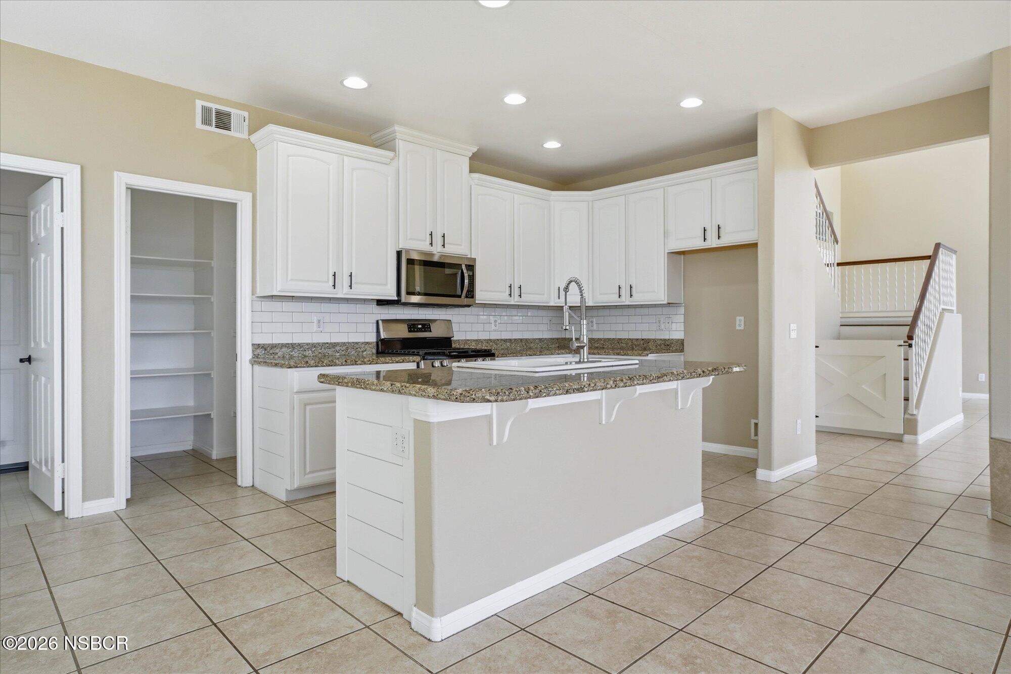 280 Rinconcito Lompoc, CA 93436 - Photo 11 of 52 a kitchen with kitchen island granite countertop a refrigerator and a sink