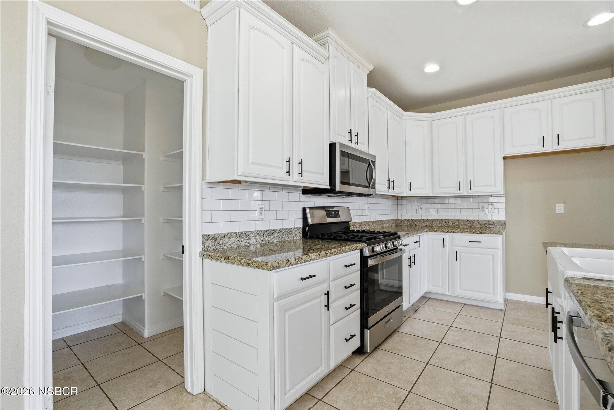 280 Rinconcito Lompoc, CA 93436 - Photo 13 of 52 a kitchen with stainless steel appliances granite countertop a stove a sink and a refrigerator