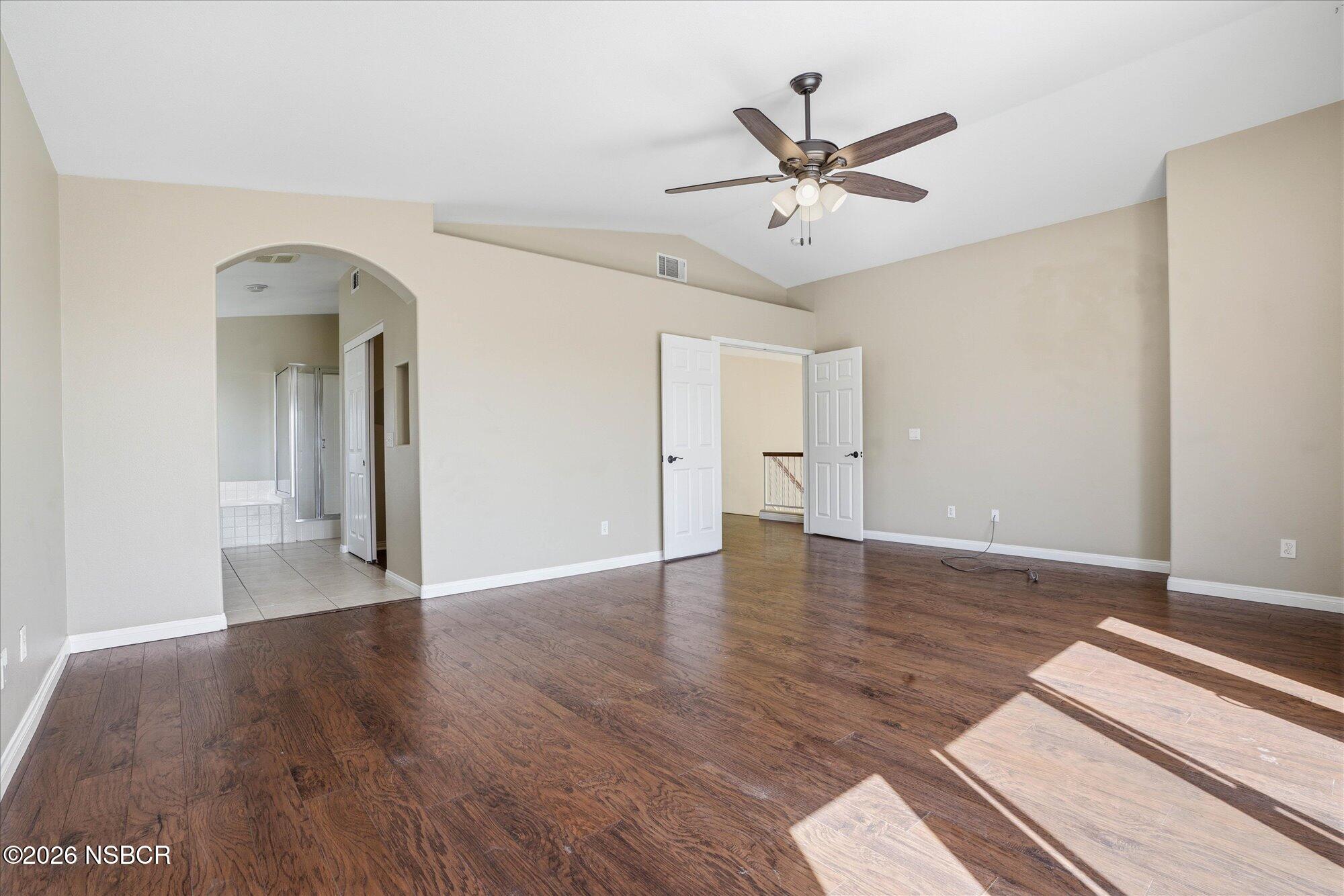 280 Rinconcito Lompoc, CA 93436 - Photo 26 of 52 a view of an empty room with wooden floor and a ceiling fan