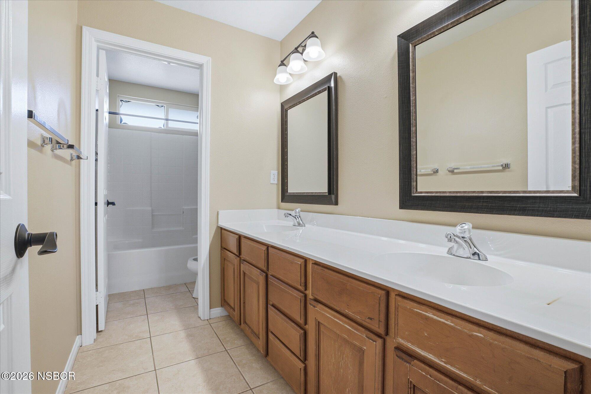 280 Rinconcito Lompoc, CA 93436 - Photo 33 of 52 a bathroom with a double vanity sink mirror and double