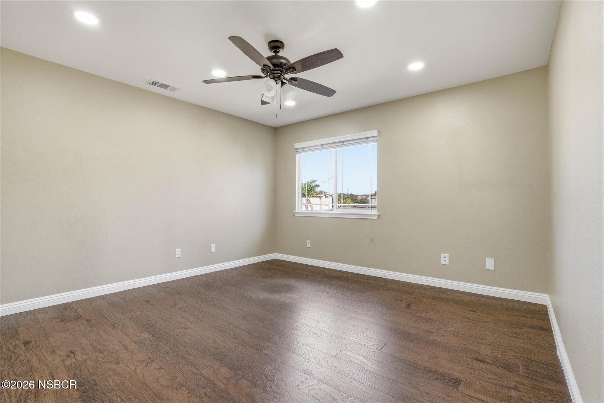 280 Rinconcito Lompoc, CA 93436 - Photo 35 of 52 an empty room with wooden floor fan and windows