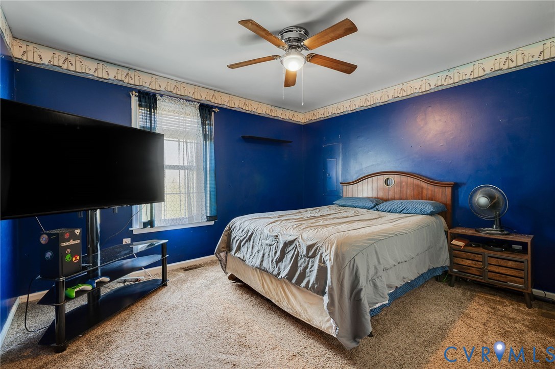 5280 West Quaker Road Disputanta, VA 23875 - Photo 33 of 33 a bedroom with a bed and a flat screen tv