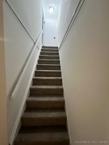 a bathroom with a toilet and a mirror