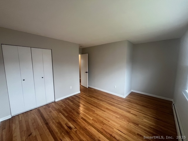 79 Beths Avenue, Unit 100 Bristol, CT 06010 - Photo 18 of 29 a view of empty room with wooden floor