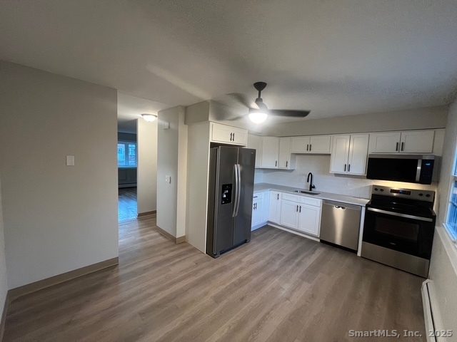79 Beths Avenue, Unit 100 Bristol, CT 06010 - Photo 7 of 29 a kitchen with stainless steel appliances granite countertop a refrigerator and a stove top oven