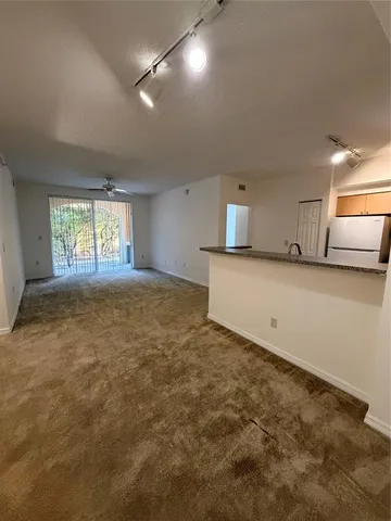 an empty room with a empty space and windows