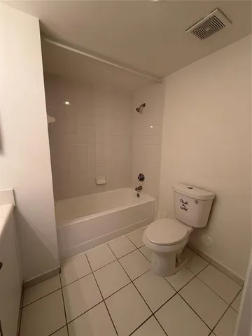a bathroom with a toilet and a bathtub