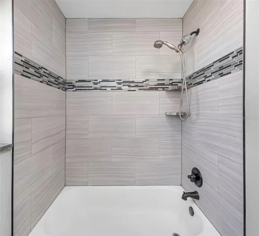 a bathroom with a shower and a bathtub