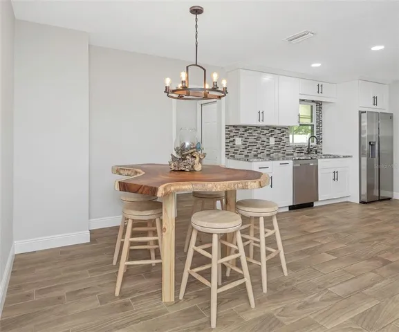 a dining room with furniture and wooden floor