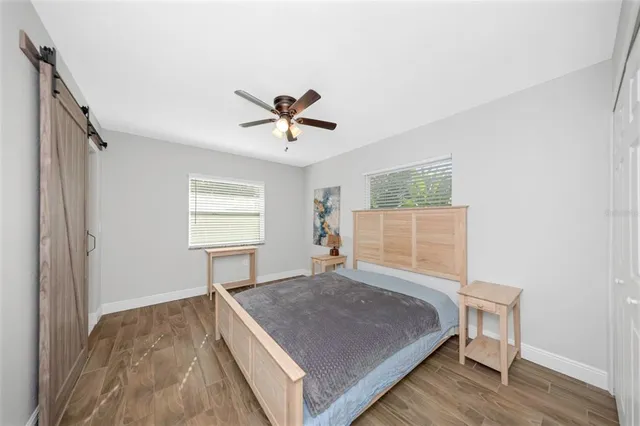 a bedroom with a bed and a chandelier