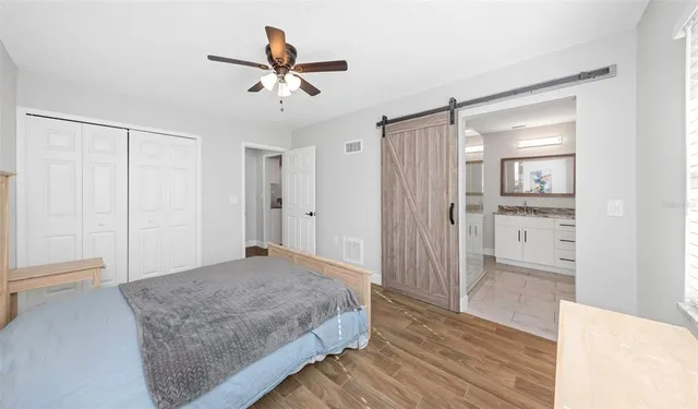 a view of a livingroom with wooden floor and a ceiling fan