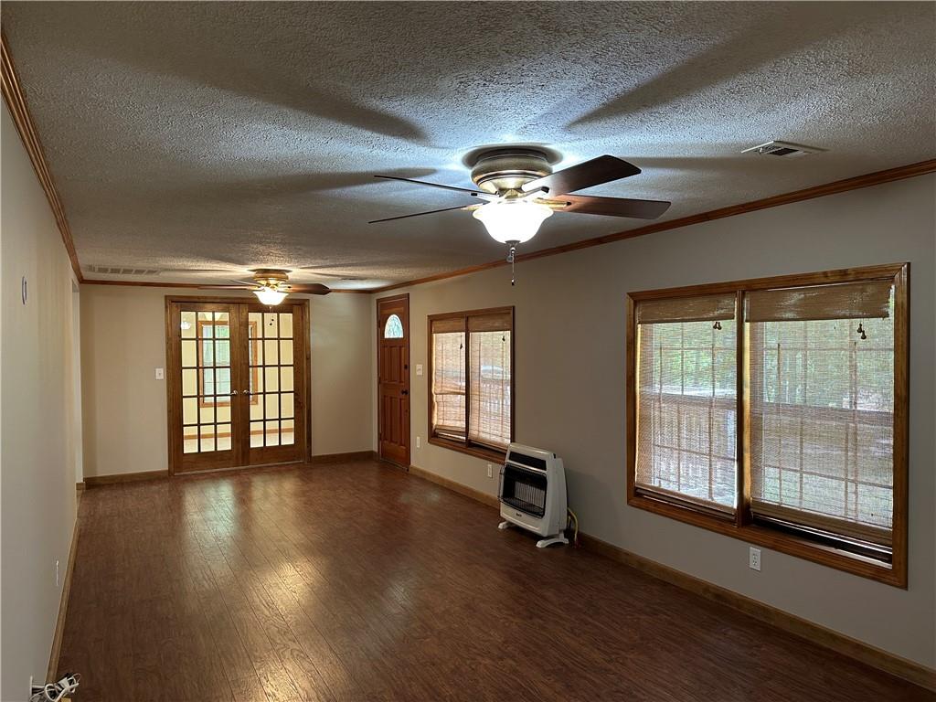 710 Spiva Road Temple, GA 30179 - Photo 8 of 31 a view of an empty room with wooden floor and a window