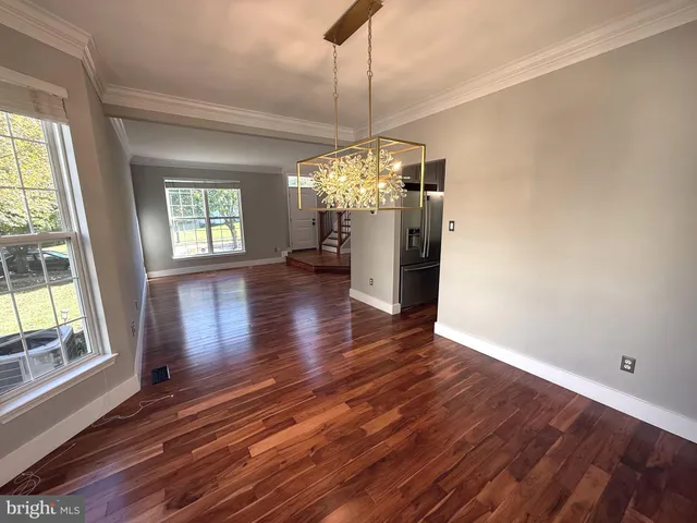 a kitchen with kitchen island a counter top space a sink appliances and cabinets