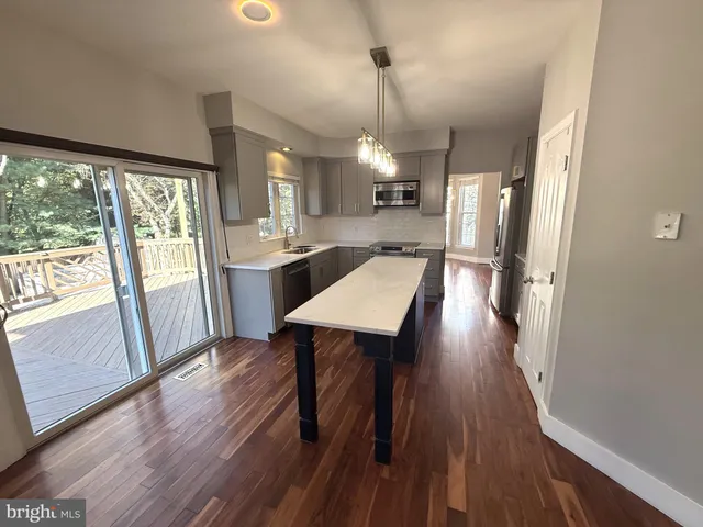 a kitchen with a refrigerator stove and microwave