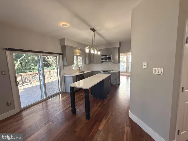 a view of staircase with railing and white walls