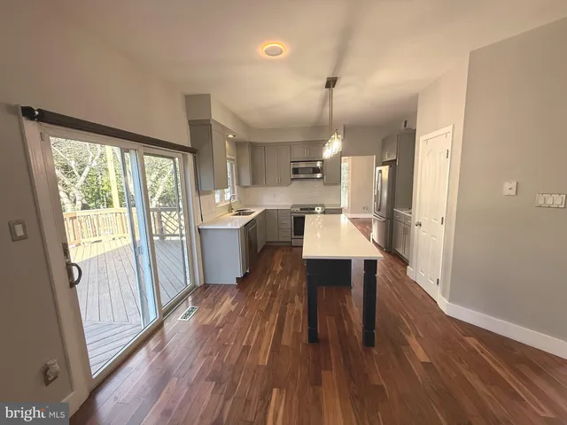 an empty room with wooden floor and white walls