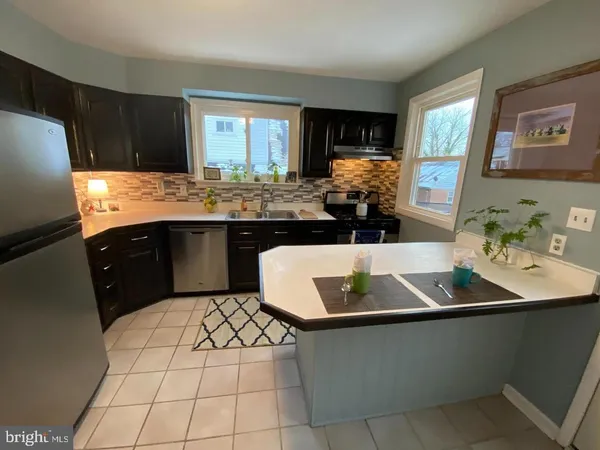 a kitchen with a sink appliances and cabinets