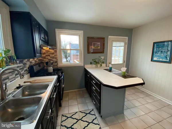 a kitchen with a sink stove and microwave