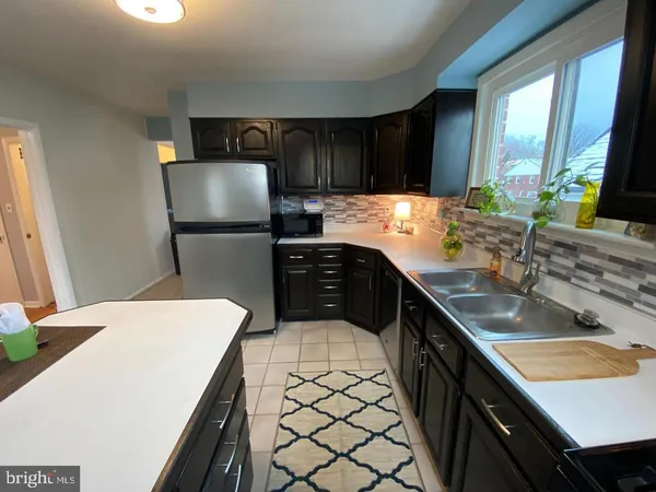 a kitchen with a sink a stove and a refrigerator
