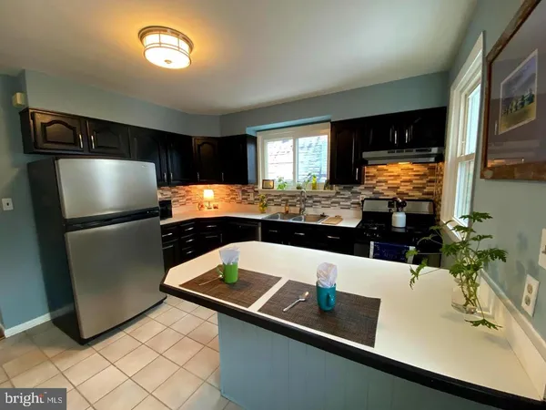 a kitchen with a sink and a refrigerator