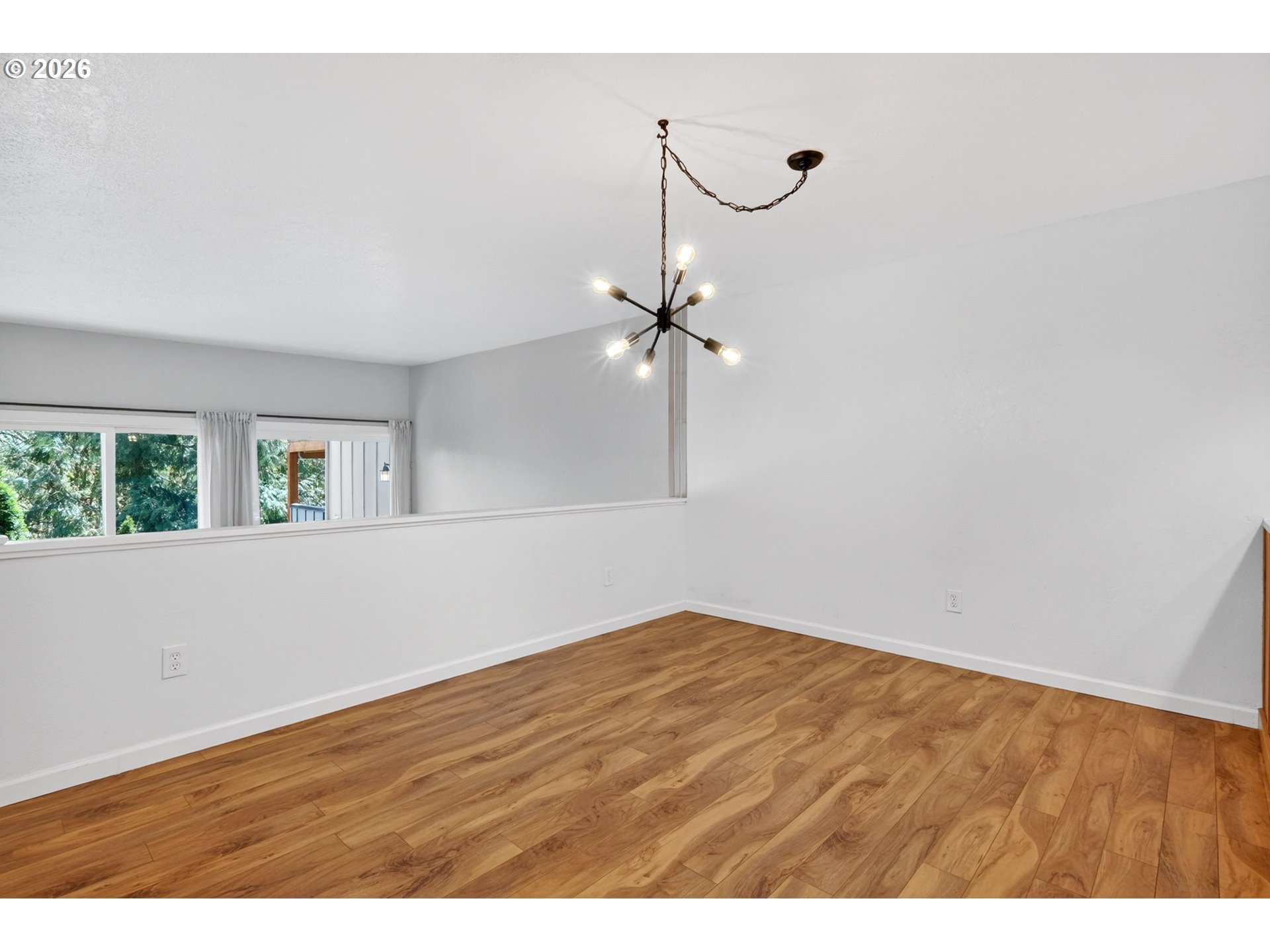 4 Touchstone, Unit 151 Lake Oswego, OR 97035 - Photo 12 of 28 a view of an empty room with wooden floor and fan