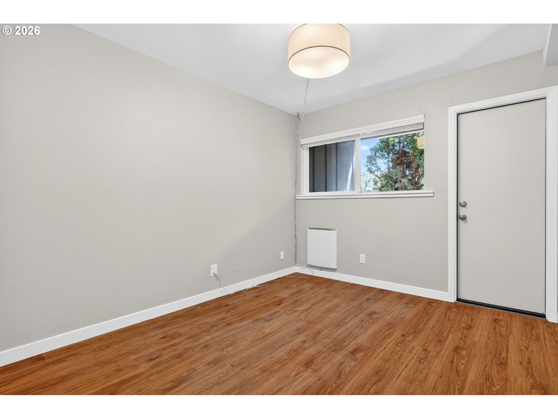 4 Touchstone, Unit 151 Lake Oswego, OR 97035 - Photo 21 of 28 a view of an empty room with wooden floor and window