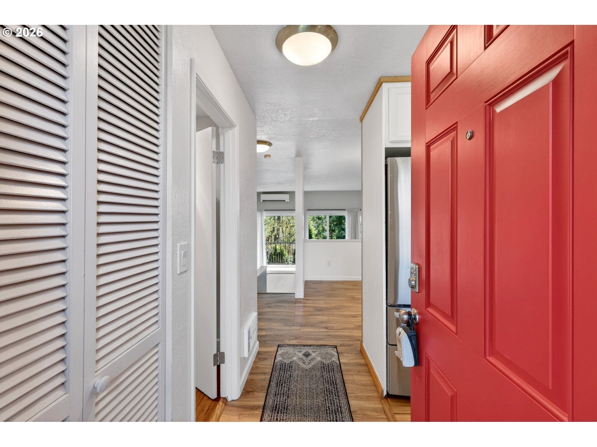 4 Touchstone, Unit 151 Lake Oswego, OR 97035 - Photo 3 of 28 a view of a bedroom with a door and wooden floor