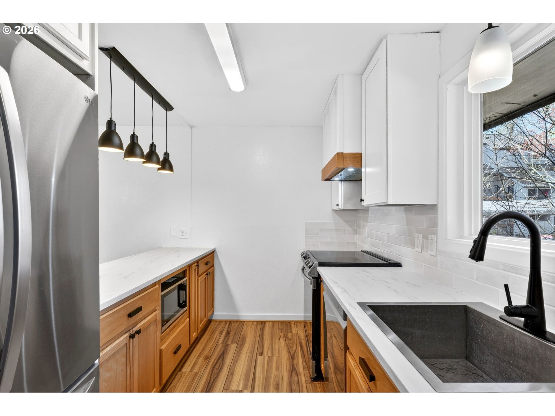 4 Touchstone, Unit 151 Lake Oswego, OR 97035 - Photo 5 of 28 a kitchen with a sink a refrigerator and cabinets