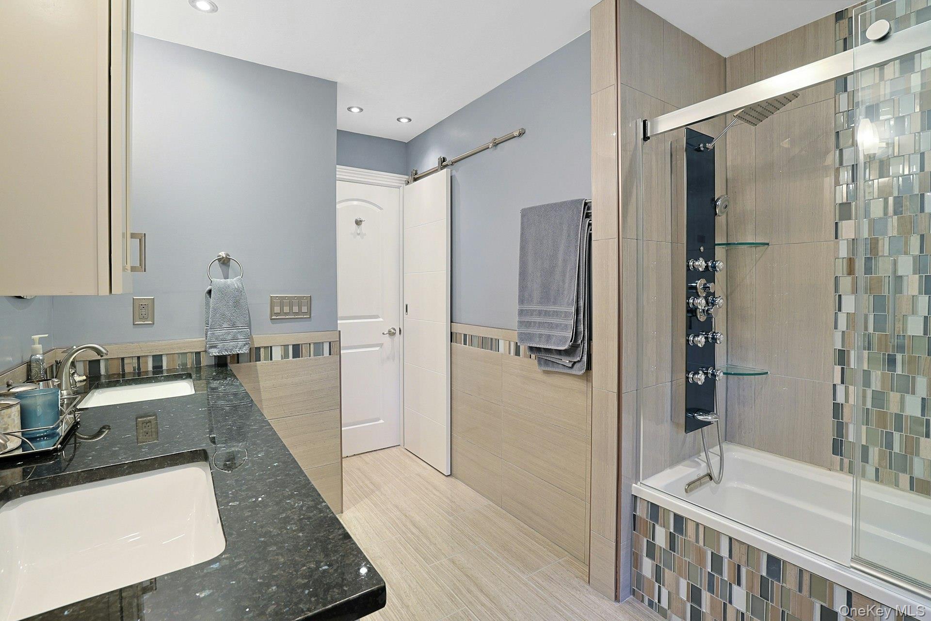 8 Dunmore Road New City, NY 10956 - Photo 38 of 48 a bathroom with a tub a sink and a large mirror