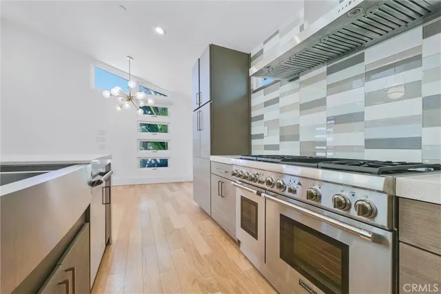 a view of an empty room with wooden floor and closet