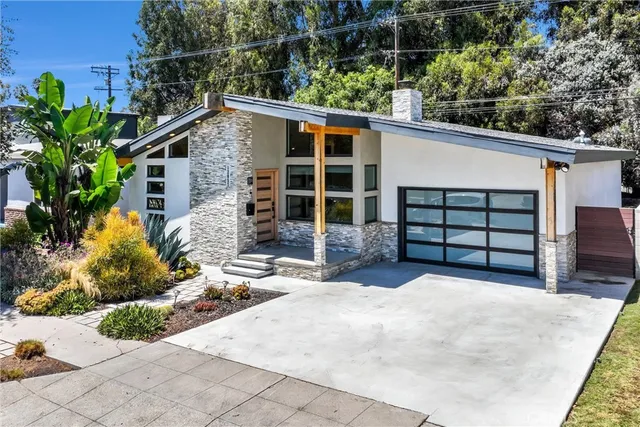 a bathroom with a sink and mirror with bathtub